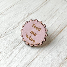 Load image into Gallery viewer, Pink wooden pin with 'Feed me wine' text on a wooden surface
