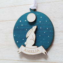 Load image into Gallery viewer, Decorative wooden ornament with a moon hare and full moon design on a blue background, featuring the name &#39;Amelia&#39;.
